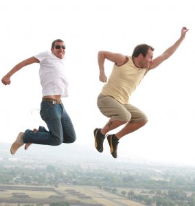two men jumping in the air to show happiness and excitement