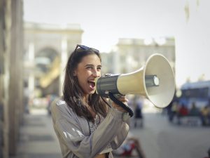Woman yelling into megaphone.