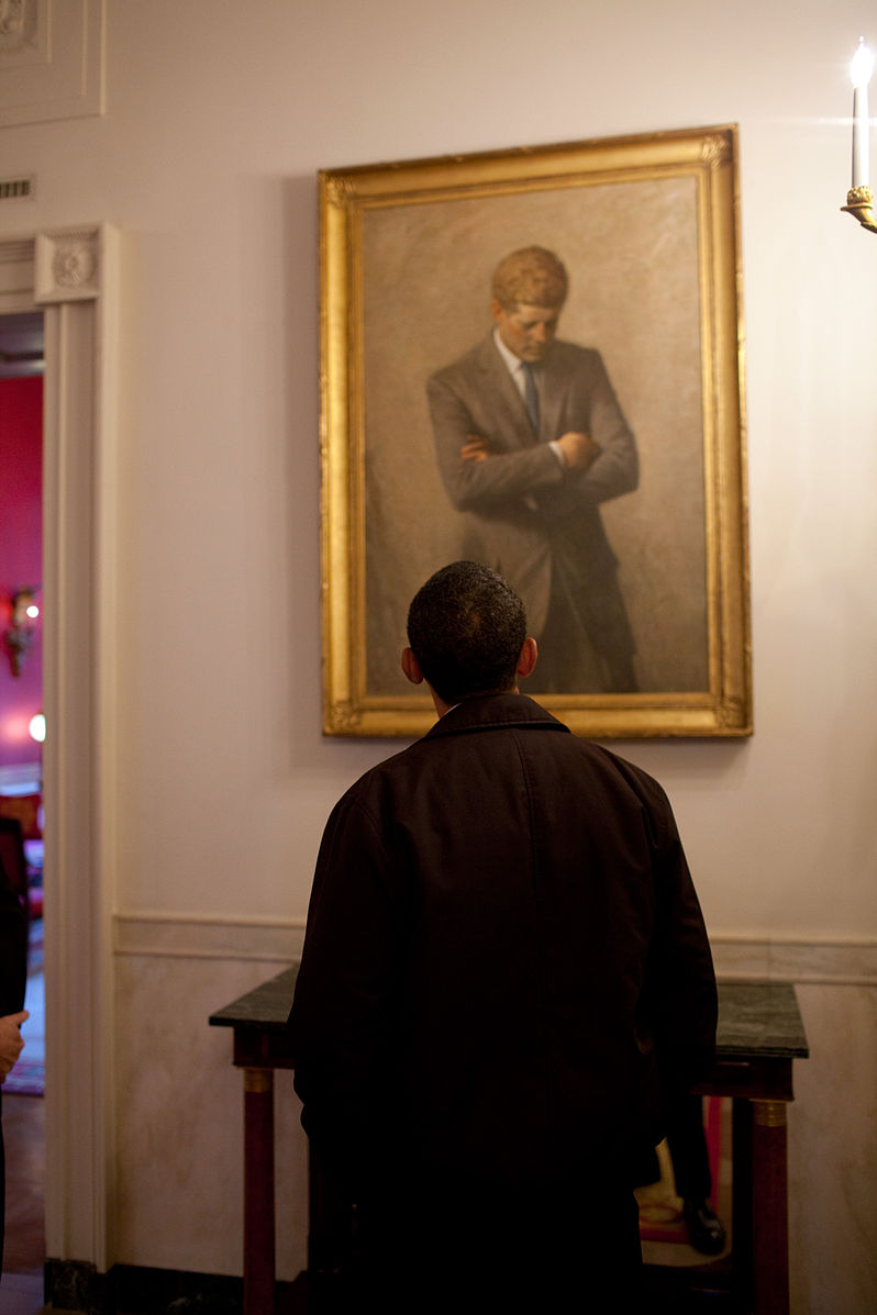 President Obama looking at a painting of President Kennedy in the White House