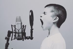 boy singing in a microphone