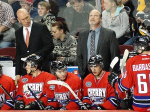 Hockey team sitting on the bench with their coach
