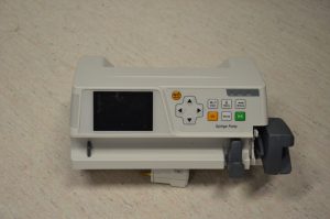 Alt text Photo of a horizontal syringe pump found in the Biomedical Engineering laboratory. The photo depicts the front view of the syringe pump.