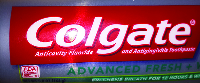 A photograph of a label of Colgate toothpaste indicating "Anticavity Fluoride".