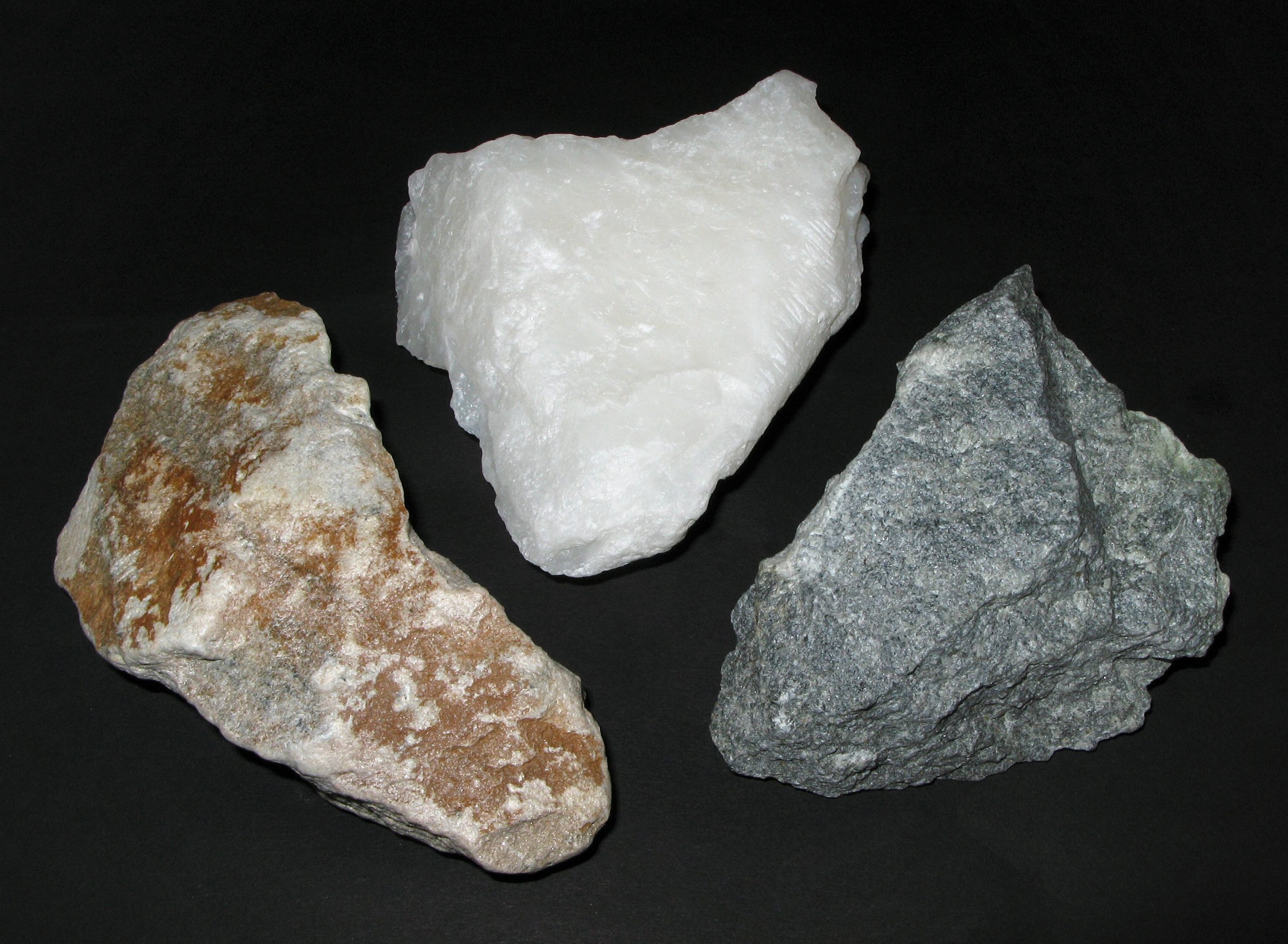 Three stones against a black backdrop are pictured.