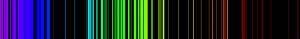 The emission spectrum of iron is pictured and has numerous overlapping emission lines in the visible part of the spectrum.