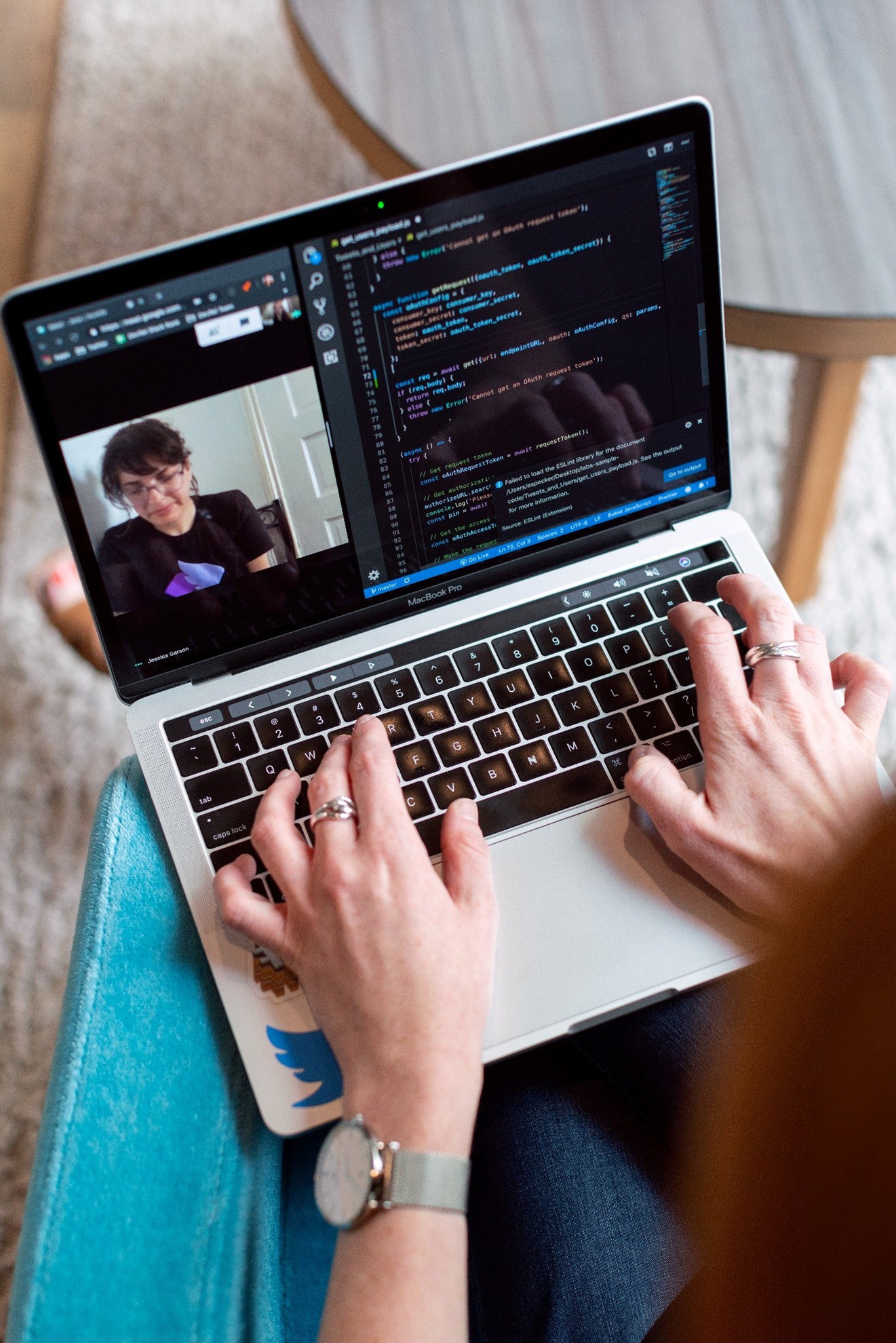 Female software engineer working online with a colleague and coding.