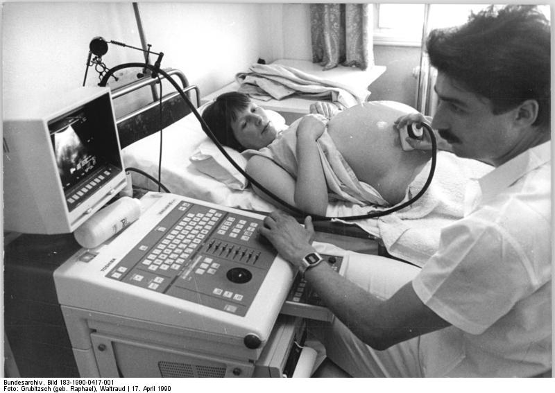 A doctor uses an ultrasound to examine a fetus.