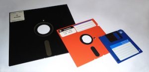 3 floppy disks of different sizes and colors (8" to 5 1/4" to 3 1/2").