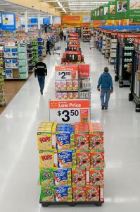 Customers at a Walmart in Gladstone, Mo. shop “Action Alley.” The displays, which had been discontinued in recent years, have returned to the company’s stores. Action alley features value and convenience items that shoppers typically look for.