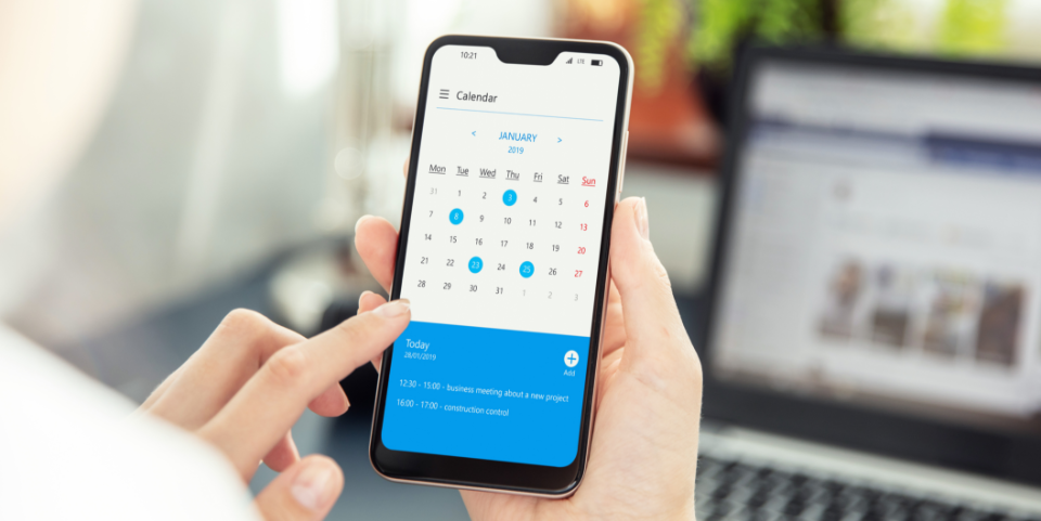 Person checking calendar on smartphone screen