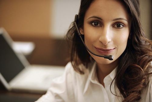 A woman wearing a phone headset.