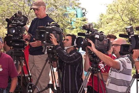 A number of news reporters with their video cameras.