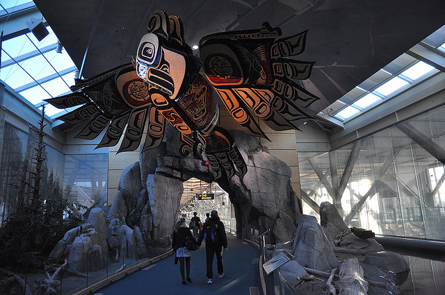 A large Haida eagle sculpture hangs from the ceiling.
