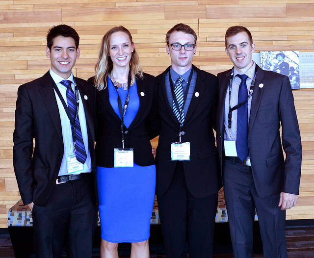 Four students dressed in formal business attire.
