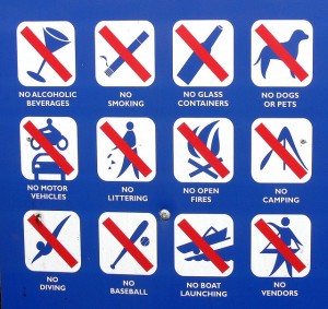 A sign listing things that are not allowed like pets, alcohol, baseball, open fires and more.