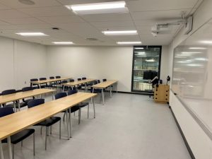 Empty classroom with podium and whiteboard