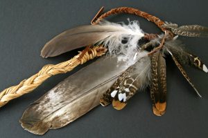 eagle and grouse feathers netted together with sweetgrass