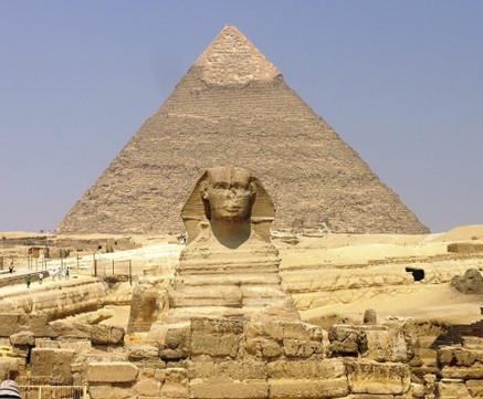 We can see the face of the Sphinx with the pyramid towering behind it.
