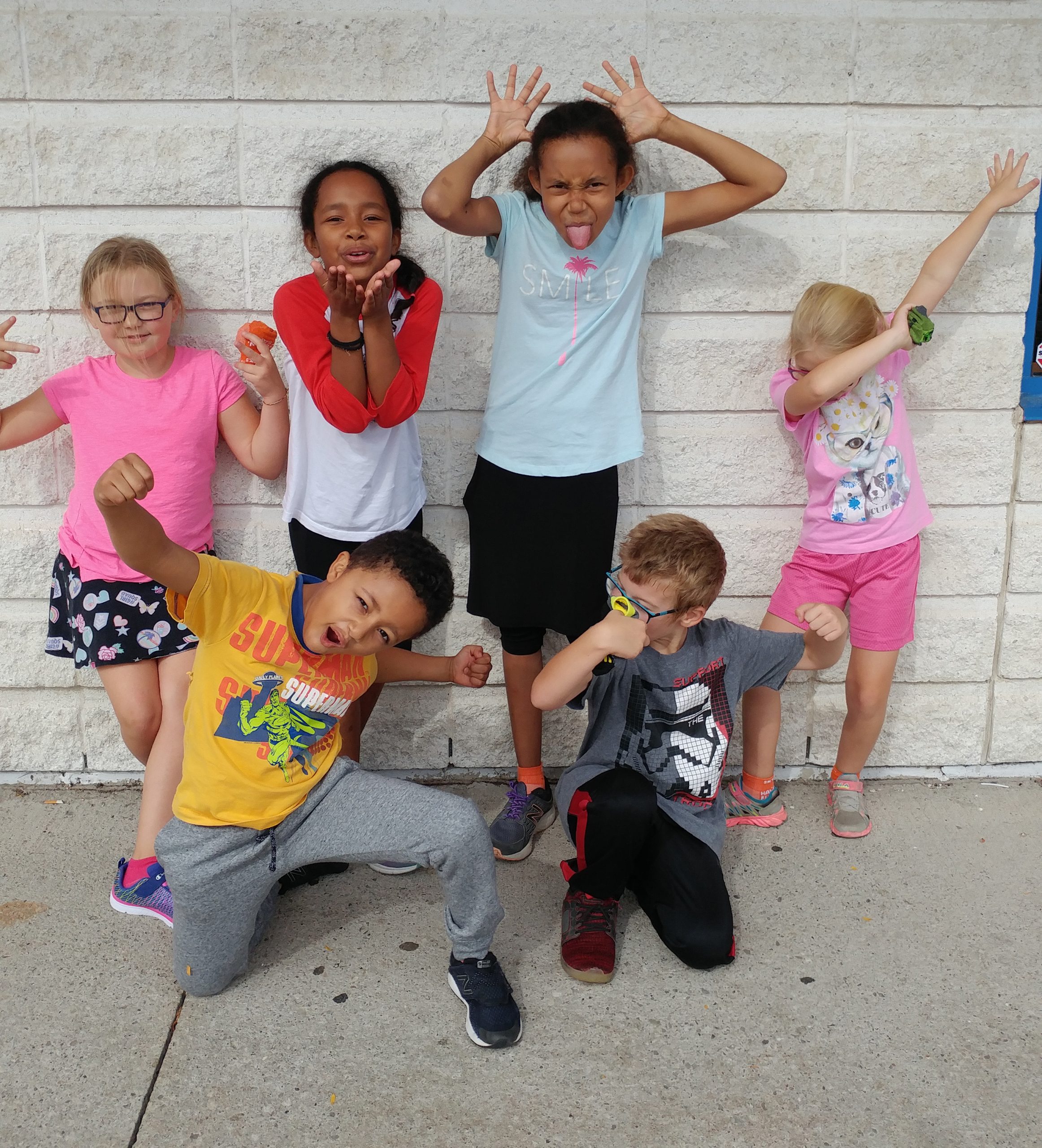 Six children show various expressive poses.
