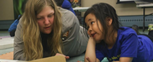 Woman teaching a child vocabulary.