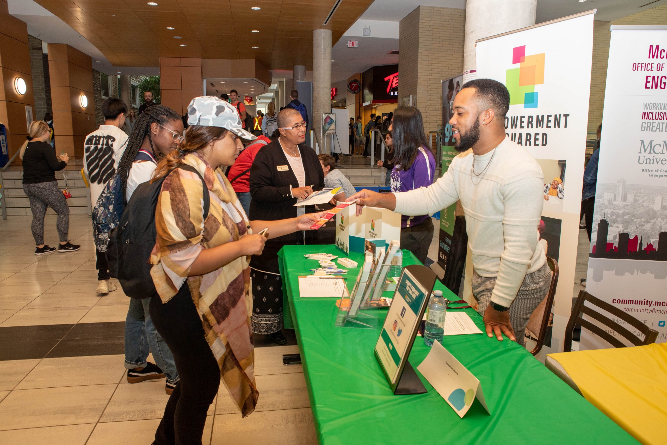 Image of students and partners at a community engagement fair in McMaster's Student Centre atrium.