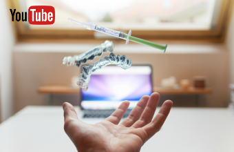 Outstretched hand with floating model and syringe in front of laptop