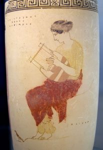 Muse playing the lyre. The rock on which she is seated bears the inscription ΗΛΙΚΟΝ / Hēlikon. Attic white-ground lekythos, 440–430 BC