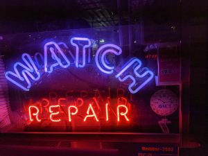 neon sign that says "watch repair"
