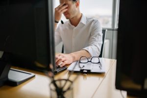 frustrated office worker in front of a computer