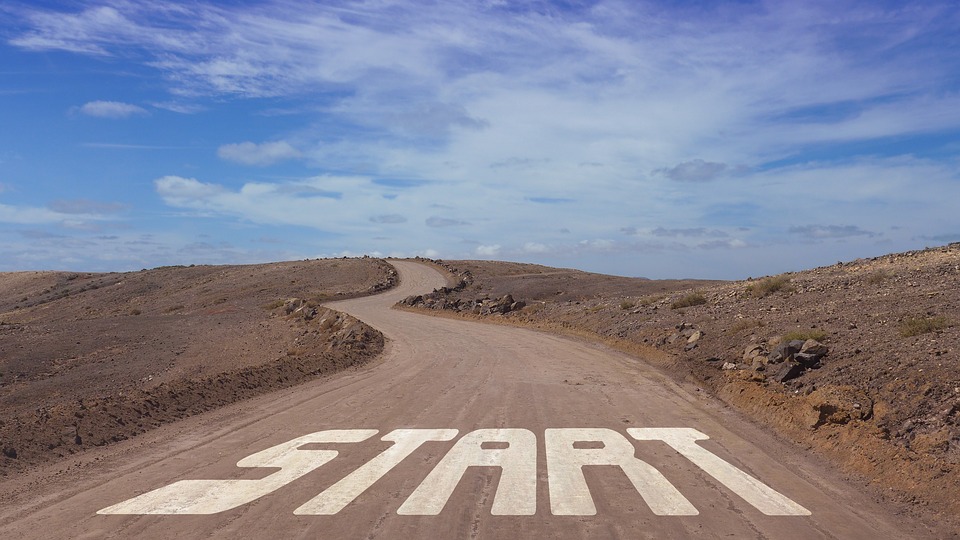 a dirt road through sandy hills, with the word start at the beginning