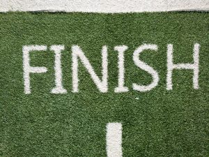 the word finish, painted on green grass