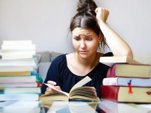 Person looking stressed while reading a book