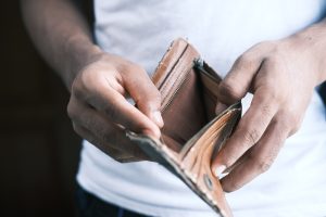 Person holding empty leather wallet