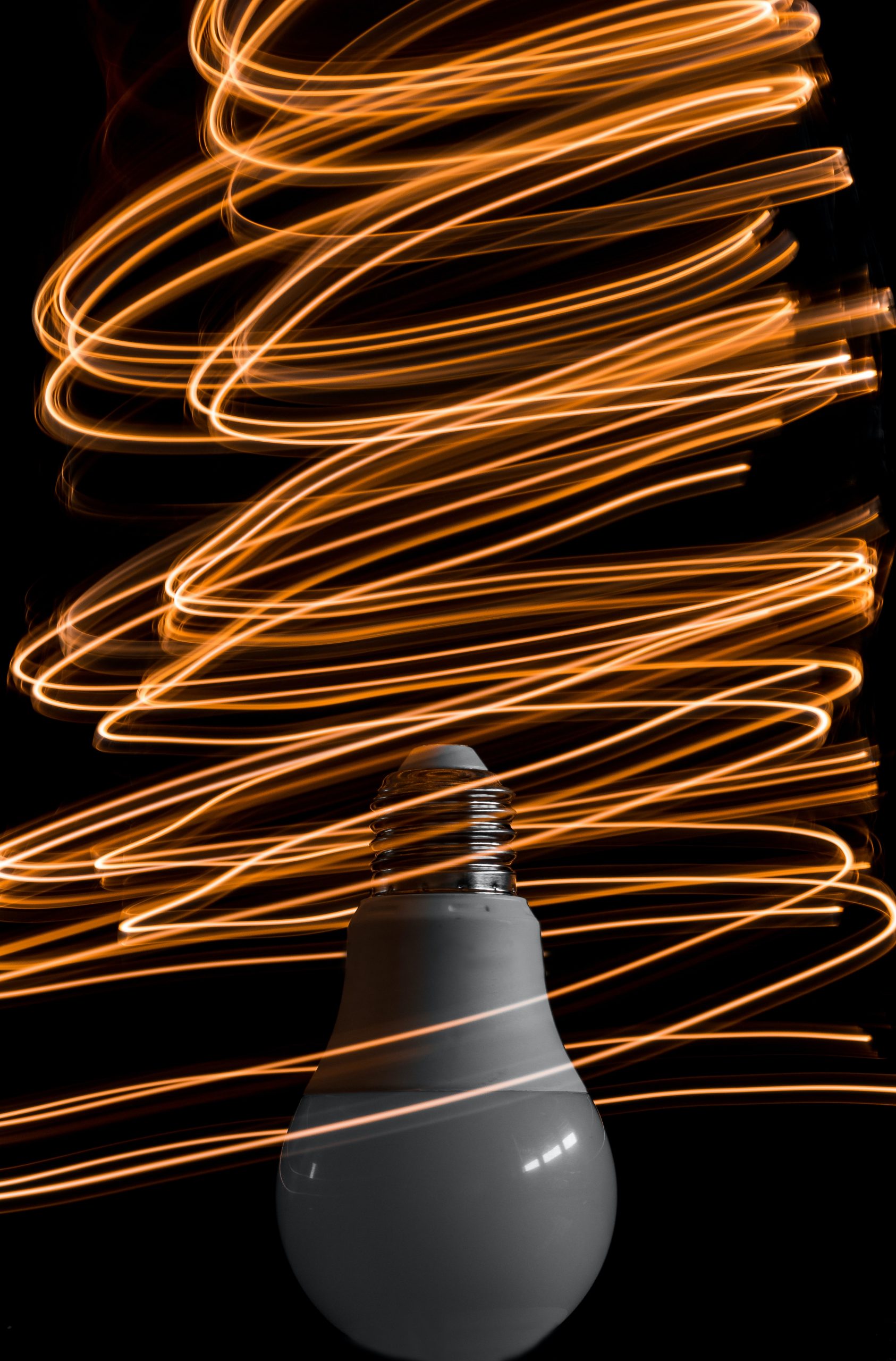 Lightbulb with light streaks circling around it.