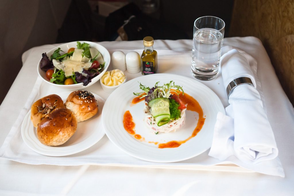 An Emirates Business Class Dinner is shown.