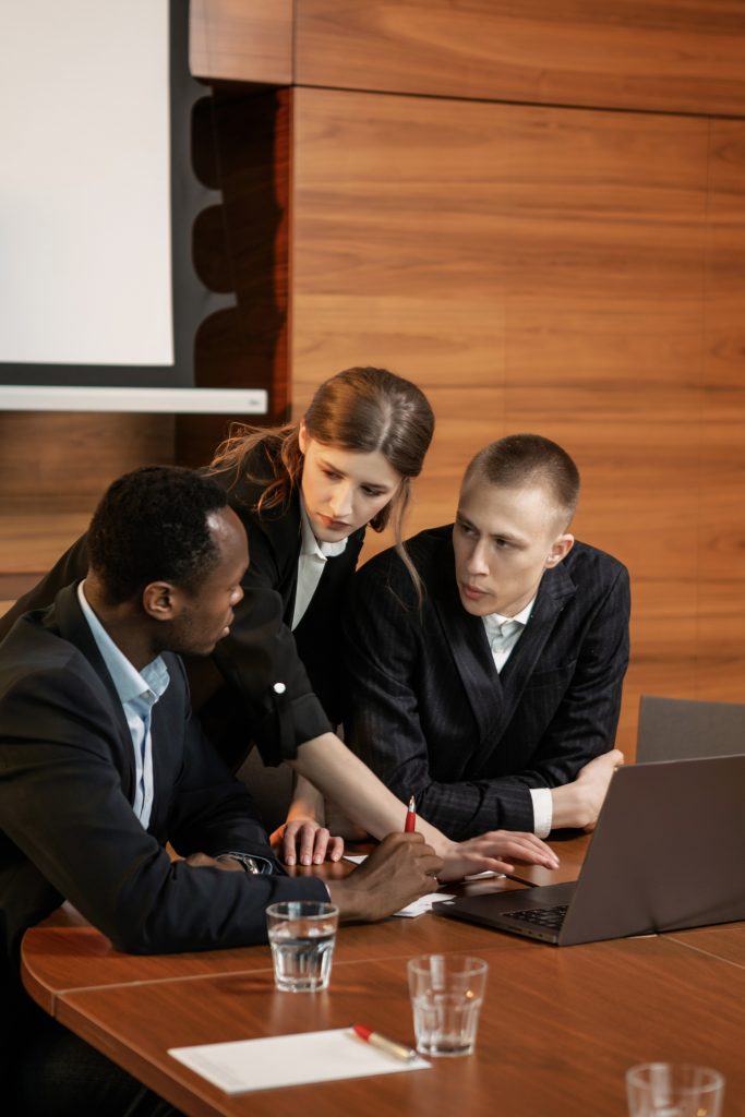 Image showing three people in a business meeting.