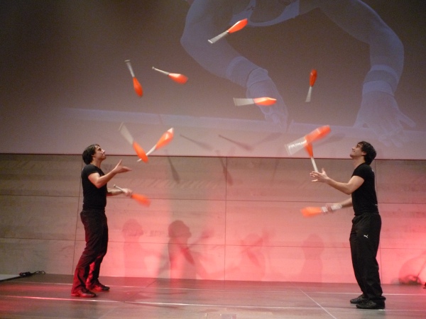 The picture shows Christoph and Manuel Mitasch passing 11 clubs (Juggling) in Linz, Austria