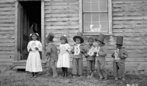 Children at Fort Simpson Indian Residential School holding letters that spell “Goodbye,