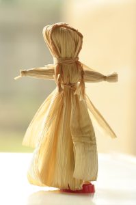 a blank faced corn husk doll