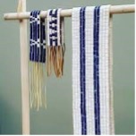 three different wampum belts hanging