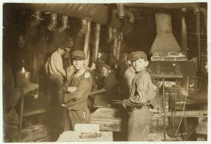 two young boys working in a factory