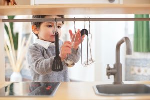 a child playing with a kitchen set