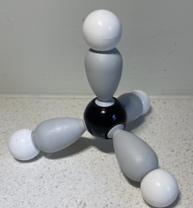 A 3D model of the structure of methane. A central black sphere representing carbon is attached to 4 white spheres representing hydrogen, using four grey teardrop-shaped bonds. The white spheres point to corners of a tetrahedron.
