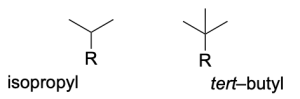 Two molecular structures, the left being isopropyl, with R bound to a branched carbon bound to two methyl groups. The right is tert-butyl, with R bound to a branched carbon bound to three methyl groups.
