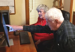 two seniors in front of a computer