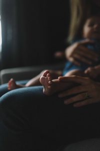 selective focus of baby on person's lap