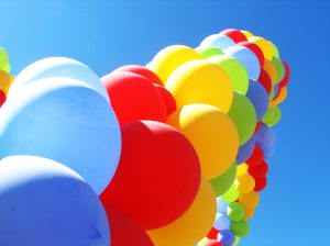 Multiple balloons of different colours are shown.