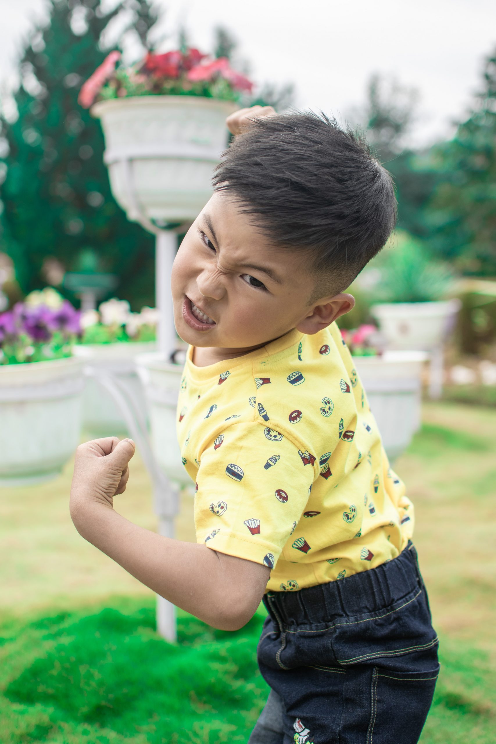 An angry young boy getting ready to punch