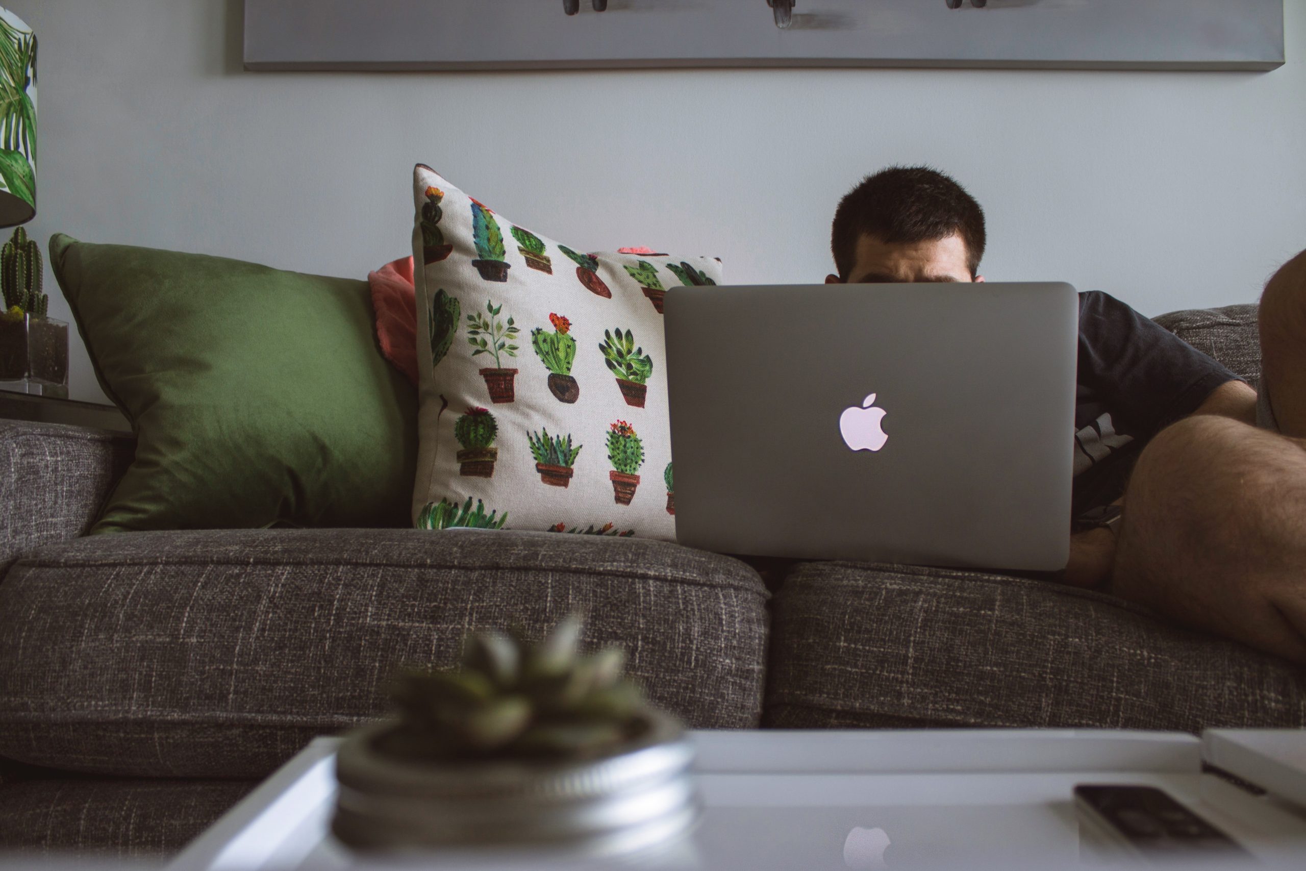 Man behind computer concealing what he is doing