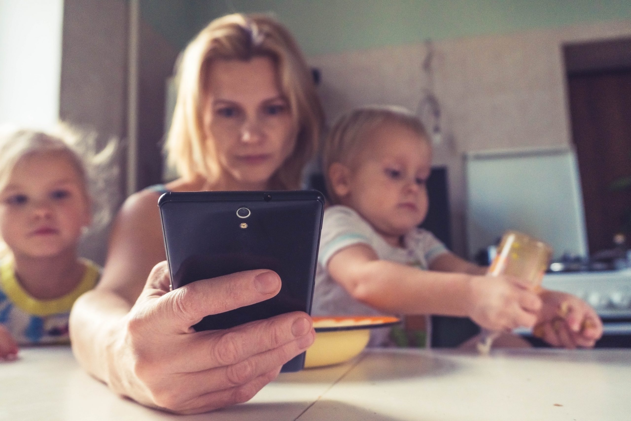 Mother on phone with children